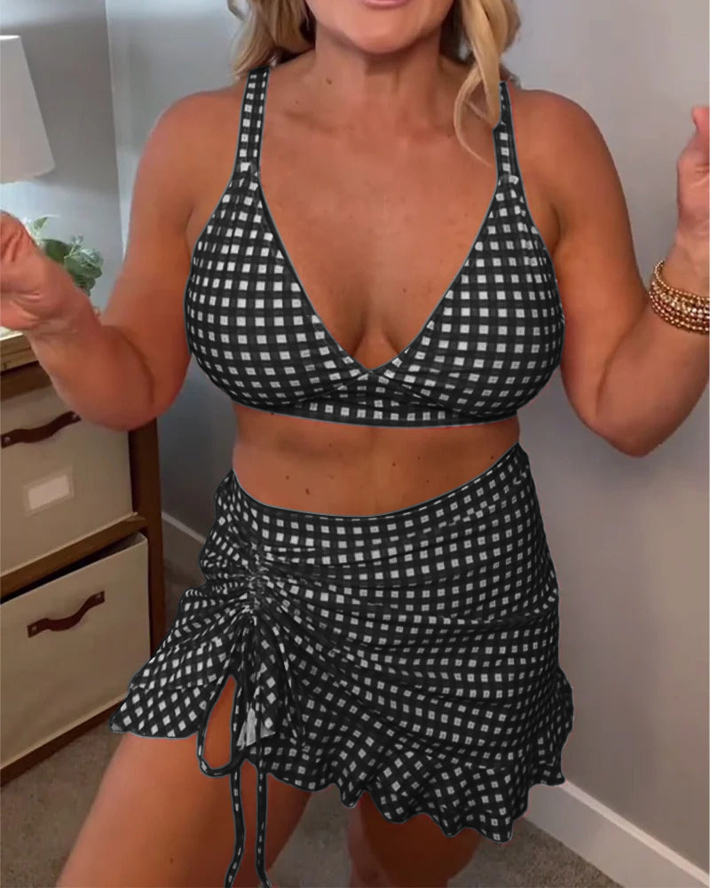 Two-piece swimsuit with a relaxed check print and straps.