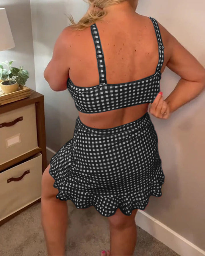 Two-piece swimsuit with a relaxed check print and straps.